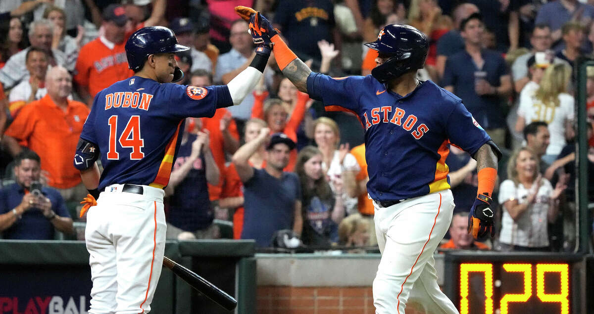 Houston Astros' Jeremy Pena, left, and Mauricio Dubon smile during