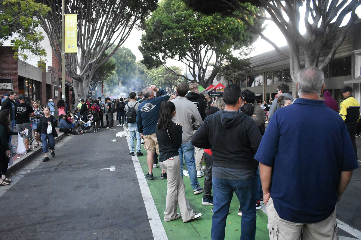 A line for the Santa Maria-style barbecue at F. McLintocks Saloon stretches down the block at the San Luis Obispo farmers' market on July 6, 2023. 