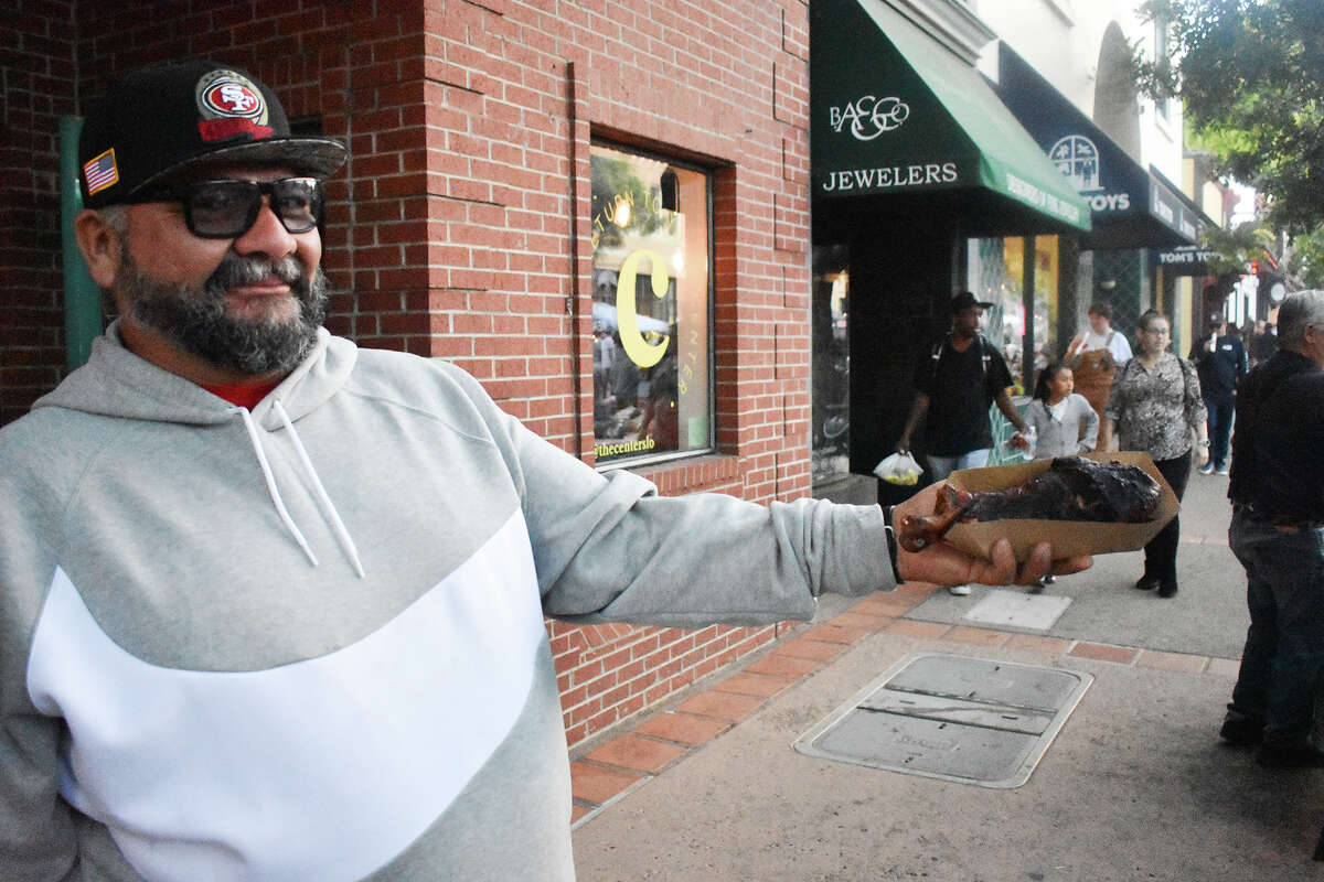 Jesus Campos of Fresno, Calif. shows off some prized Santa Maria-style barbecue at the San Luis Obispo farmers' market on July 6, 2023. 