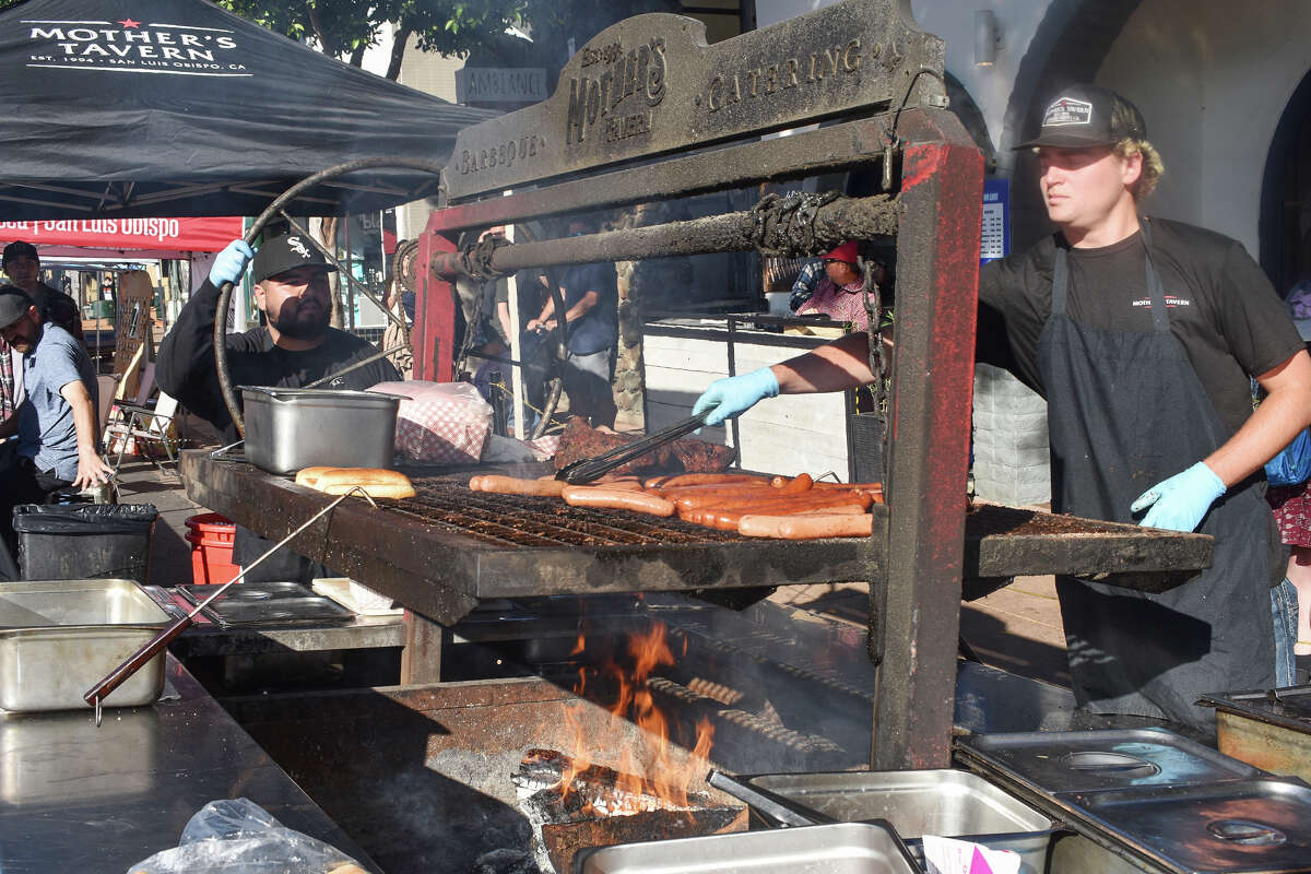 Cooks in front of Mother's Tavern in San Luis Obispo prepare Santa Maria-style barbecue at the San Luis Obispo farmers' market on July 6, 2023. 