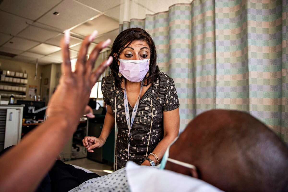 Dr. Monica Gandhi interacts with a patient at Zuckerberg San Francisco General Hospital on Oct. 1, 2021. She was one of the infectious disease experts who participated in Dr. Bob Wachter’s roundtable about COVID last week.