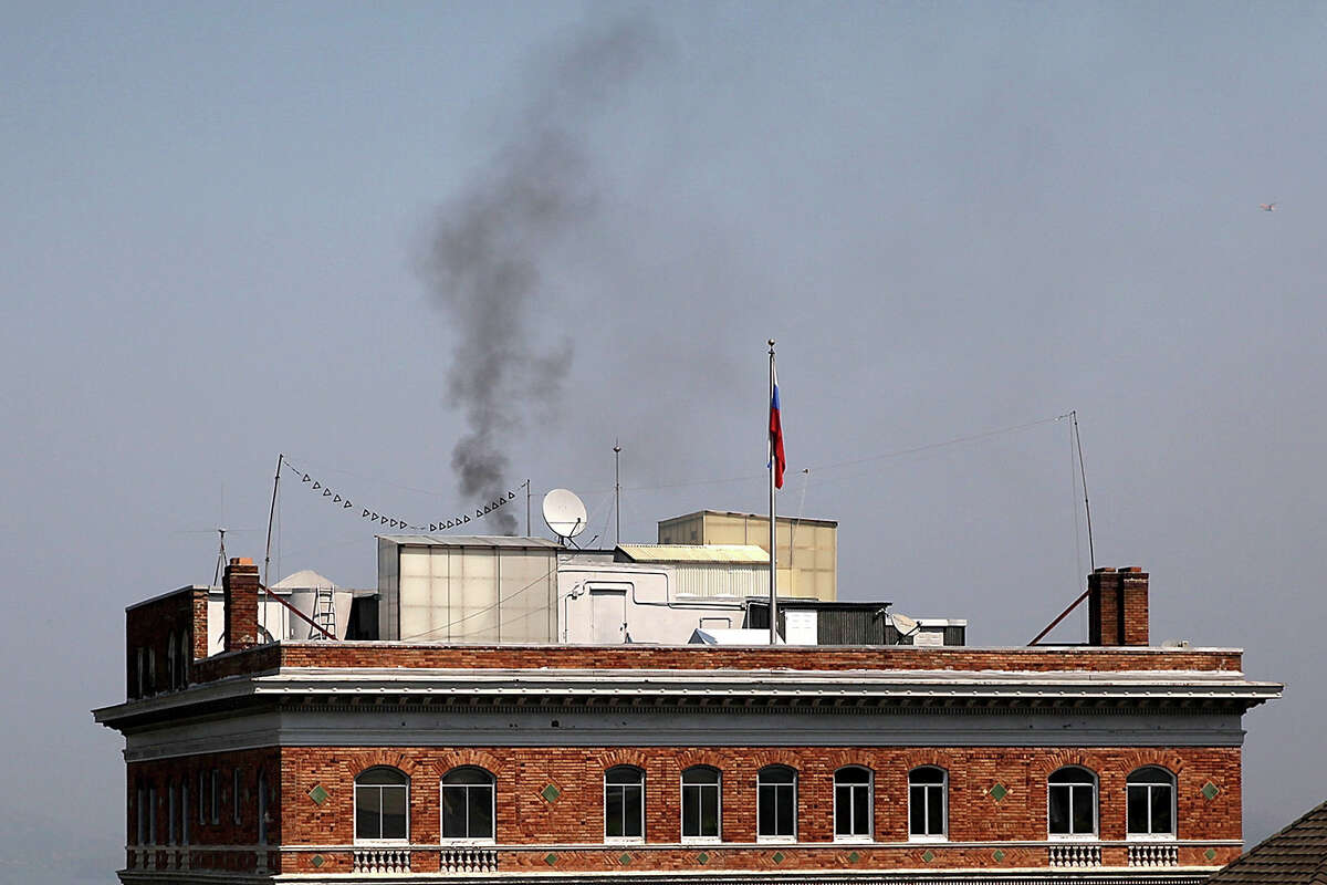 FILE: Black smoke billows from a chimney on top of the Russian consulate on Sept. 1, 2017, in San Francisco. In response to a Russian government demand for the United States to cut its diplomatic staff in Russia by 455, the Trump administration ordered the closure of three consular offices in San Francisco, New York and Washington. 