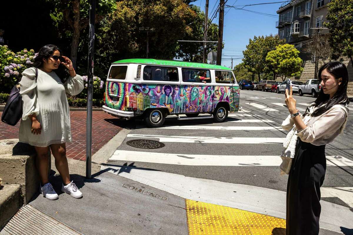 A tour bus travels Lombard Street, a big attraction for tourists.