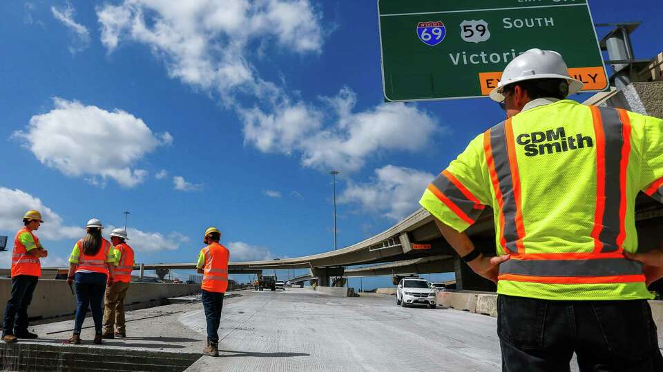 Fernando De La Garza looks over at TXDot employees on the Interstate Highway Loop 610 Southbound construction site on Thursday, July 13, 2023 in Houston.