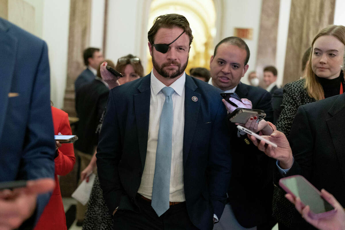 Rep. Dan Crenshaw, R-Texas, talks to reporters as he walks out of the House chamber as voting continued for a second day to elect a speaker and convene the 118th Congress in Washington, Wednesday, Jan. 4, 2023. (AP Photo/Jose Luis Magana)