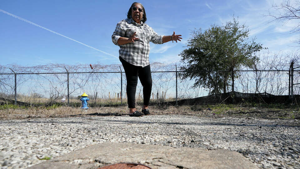 A test well is shown as Kathy Blueford-Daniels, a Fifth Ward resident and community activist, talks about health concerns in the area near her home from the creosote contamination at the former Union Pacific Railroad site wood treatment facility shown Monday, Feb. 14, 2022, in Houston. Residents had previously picketed at the contaminated rail yard on Valentine's Day, but decided not to picket as they are frustrated and tired of fighting.