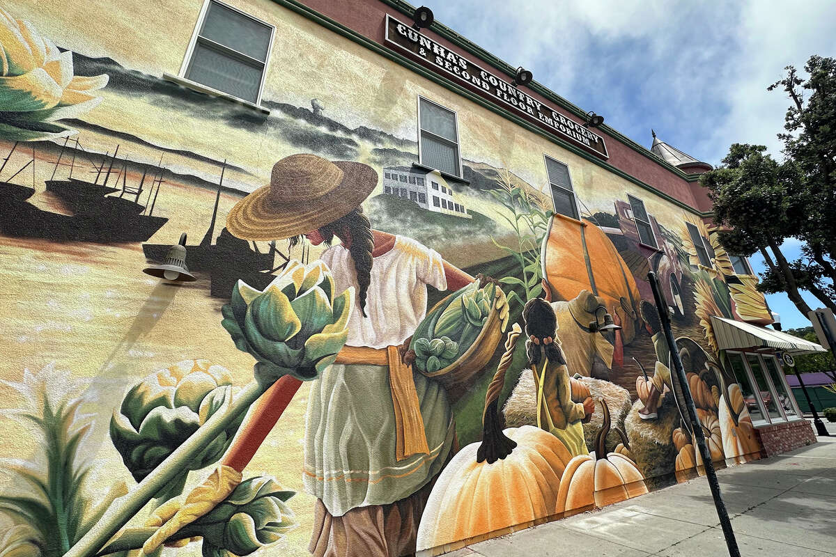 A mural by artist Julie Engelmann on the side of Cunha Country Store features an image of harvest that celebrates the decades-old Half Moon Bay Art and Pumpkin Festival.