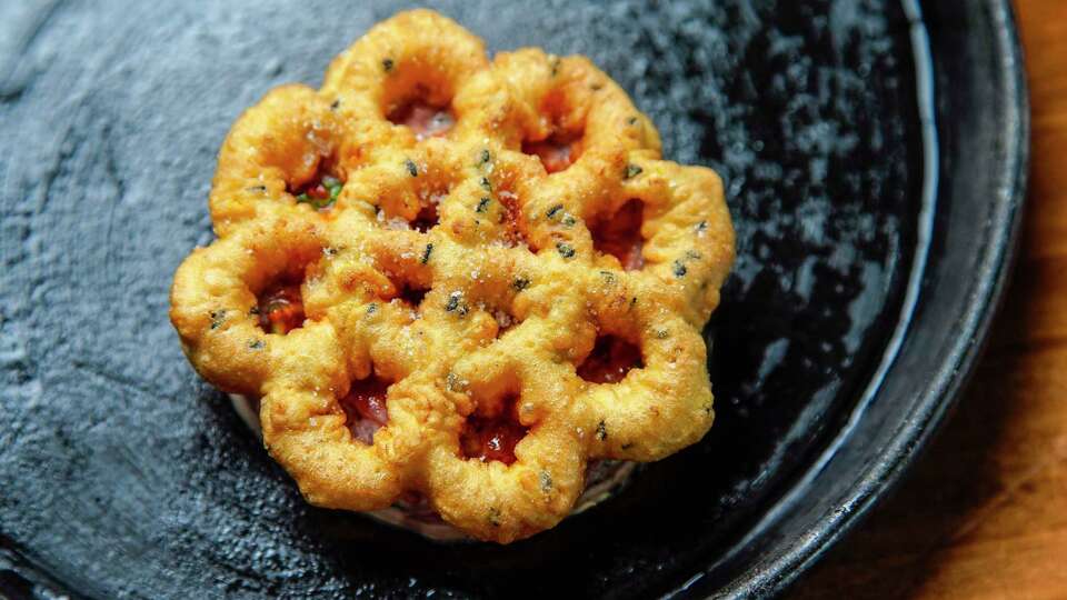 Beef tartare with toasted rice, egg yolk, citronette, and bunuelo photographed at Jun on Thursday, July 13, 2023 in Houston.