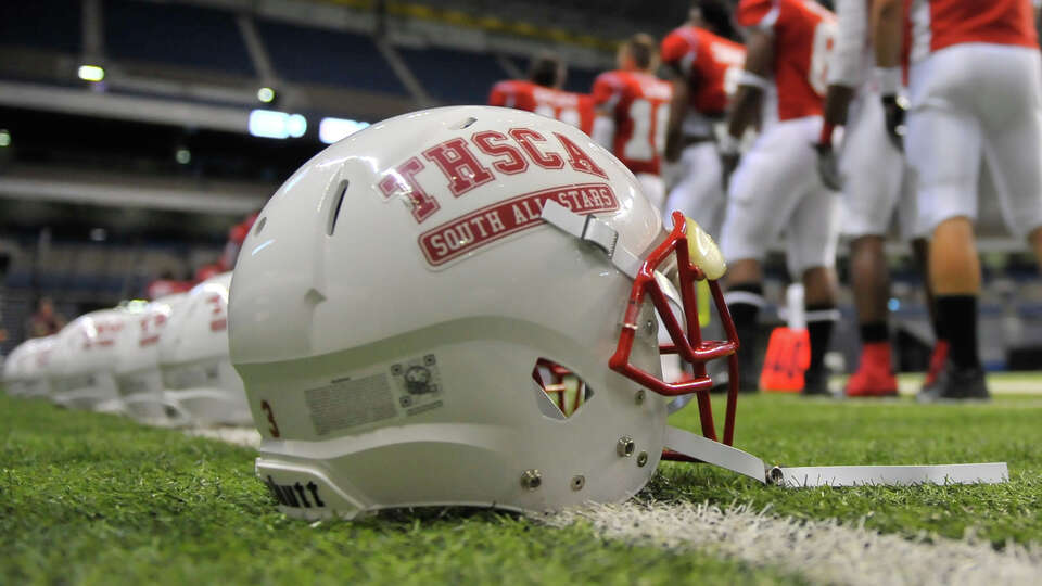 Players for the South All-Stars line up before the Texas High School Coaches Association All-Star game at the Alamodome Tuesday evening.