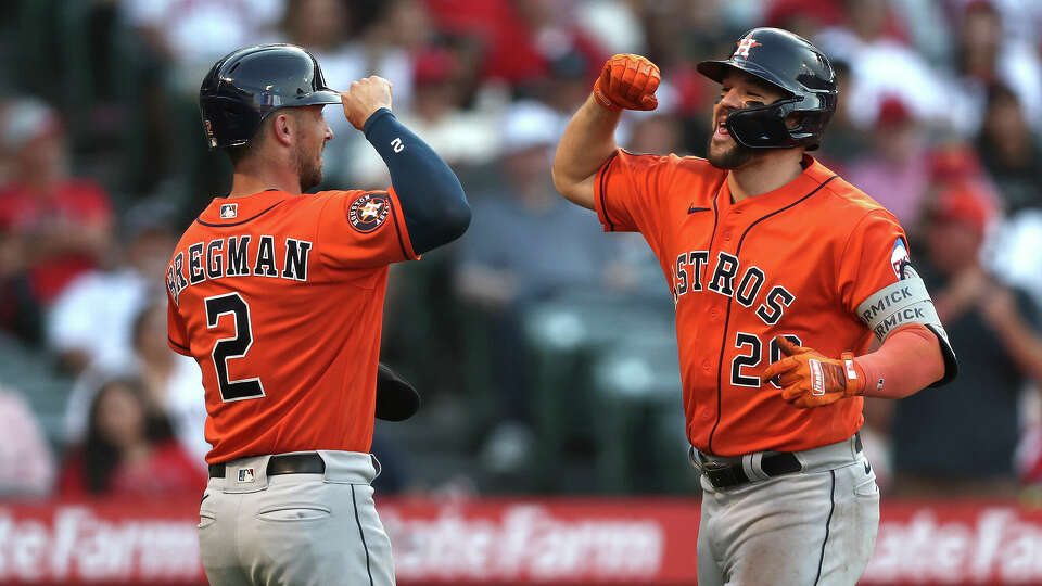 ANAHEIM, CALIFORNIA - JULY 16: Chas McCormick #20 of the Houston Astros celebrates with his teammate Alex Bregman #2 after hitting a two run home run against the Los Angeles Angels during the eighth inning at Angel Stadium of Anaheim on July 16, 2023 in Anaheim, California. (Photo by Michael Owens/Getty Images)