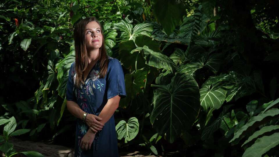 Lizzy McGee poses for a portrait Monday, July 17, 2023, in the Cockrell Butterfly Center at the Houston Museum of Natural Science in Houston. She said she really enjoyed spending time in the butterfly exhibit. She also said she plans to start a Texas-themed amusement park.