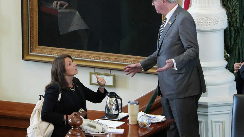 State Sen. Angela Paxton, R-McKinney, talks to Texas Lt. Gov. Dan Patrick in the Senate Chamber at the Capitol in Austin, Texas, before the Senate was expected consider the rules for the impeachment of her husband Texas Attorney General Ken Paxton, Tuesday June 20, 2023. (Jay Janner/Austin American-Statesman via AP)