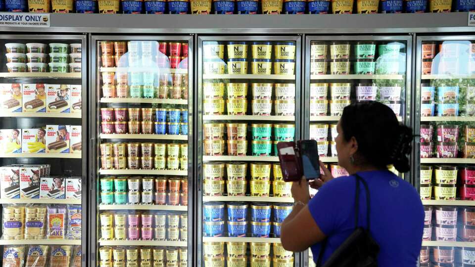 A visitor photographs a display in the ice cream parlor at Blue Bell Creameries, 1101 South Blue Bell Rd., on Tuesday, July 18, 2023 in Brenham.