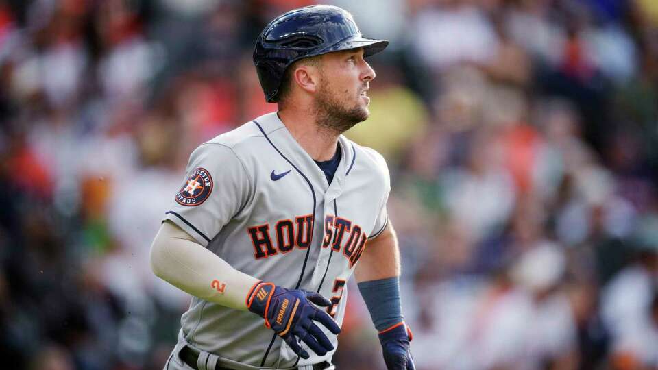 Houston Astros' Alex Bregman watches his RBI double off Colorado Rockies starting pitcher Jake Bird during the first inning of a baseball game Tuesday, July 18, 2023, in Denver. (AP Photo/David Zalubowski)