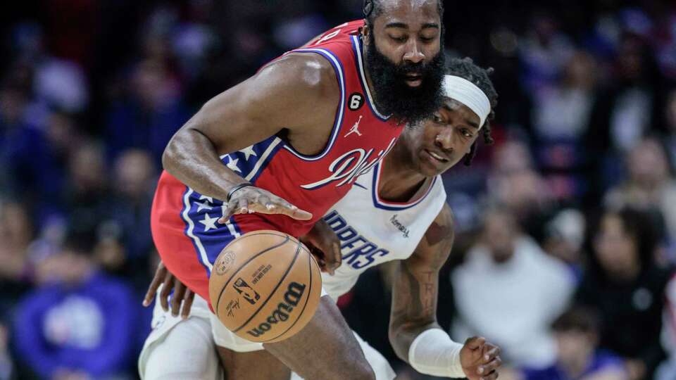 The Philadelphia 76ers' James Harden drives as the Los Angeles Clippers' Terance Mann, rear, defends during the second quarter at the Wells Fargo Center on Friday, Dec. 23, 2022, in Philadelphia.