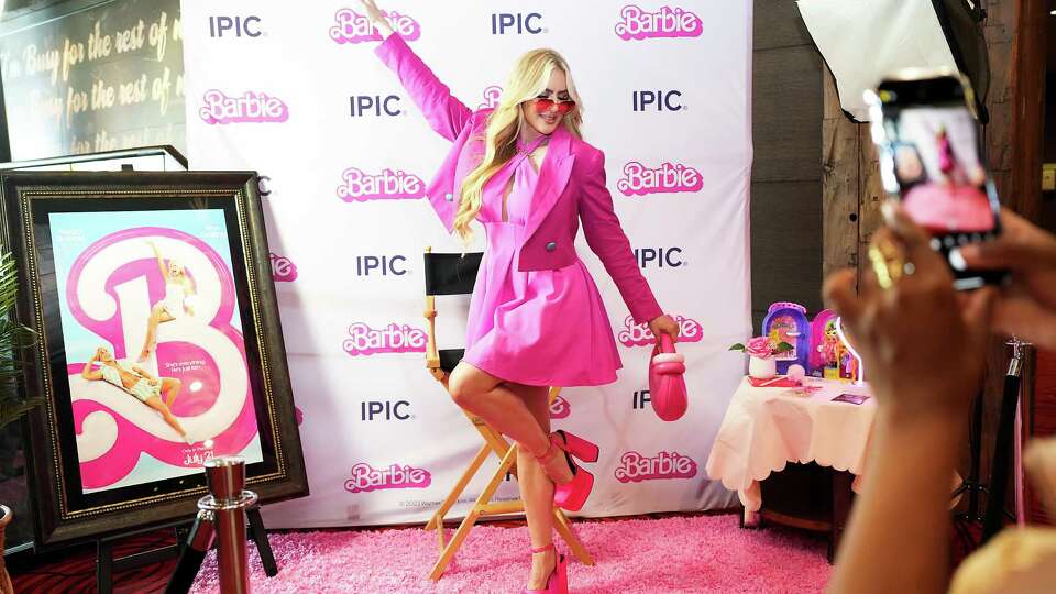 Sarah Pappas gets her photo taken during a party for those attending the advance screening of Barbie at iPic Theater on Wednesday, July 19, 2023 in Houston.