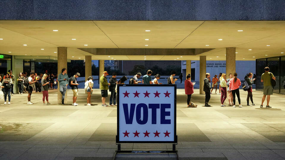 FILE - Voters wait in line at a polling place at the Lyndon B. Johnson School of Public Affairs in Austin, Texas, on election night Nov. 8, 2022. Midterm voters under 30 went 53% for Democrats compared to 41% for Republicans nationwide. That was down from such voters supporting President Joe Biden over his predecessor, Donald Trump, by a 61% to 36% in 2020, according to AP VoteCast, a sweeping national survey of voters in November's election. (Jay Janner/Austin American-Statesman via AP, File)