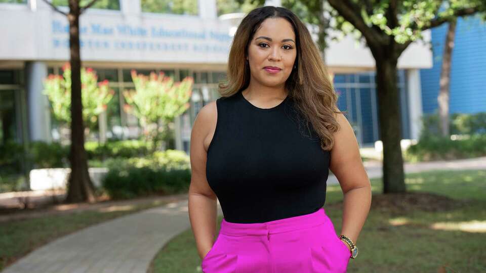 HISD Middle School teacher Crystal Evans poses in front of the Hattie Mae White Educational Support Center in Houston, TX on July 20, 2023. Evans, who has been a teacher in HISD for 10 years, is waiting to get her new salary in writing.