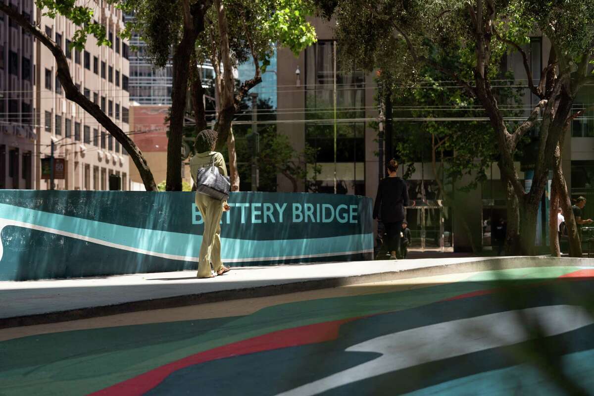 Pedestrians walk in the Financial District of San Francisco. The city has been dogged by coverage of its “doom loop” scenario.
