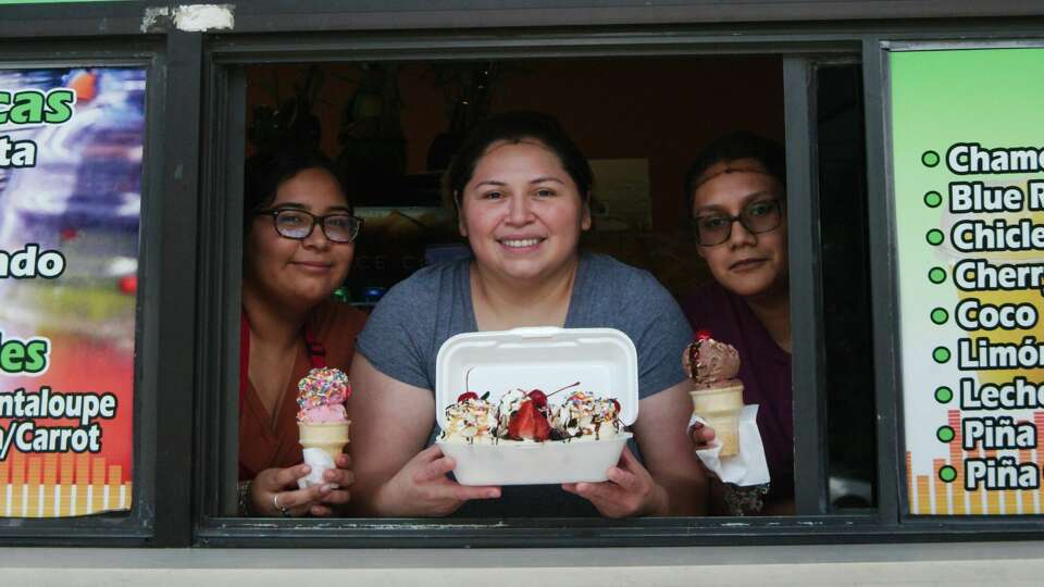 Natalie Perez, Yvette Escamilla and Alondria Secundino show off popular ice cream treats offered at Refresqueria El Caribeno Tuesday, July 18, 2023.