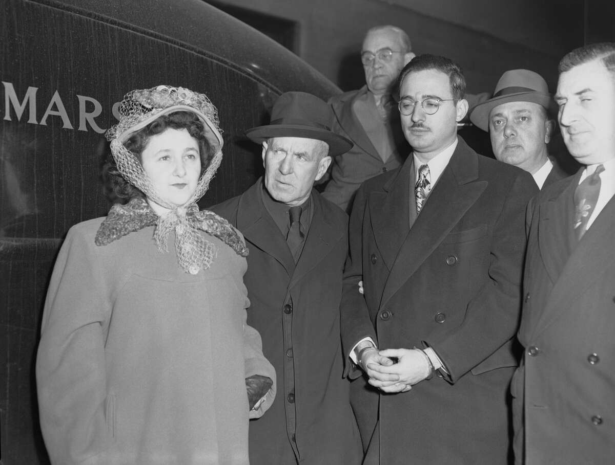 Julius and Ethel Rosenberg are escorted into a U.S. Court in New York by Deputy Marshal Harry McCabe (center) for the opening of their trial in 1951.