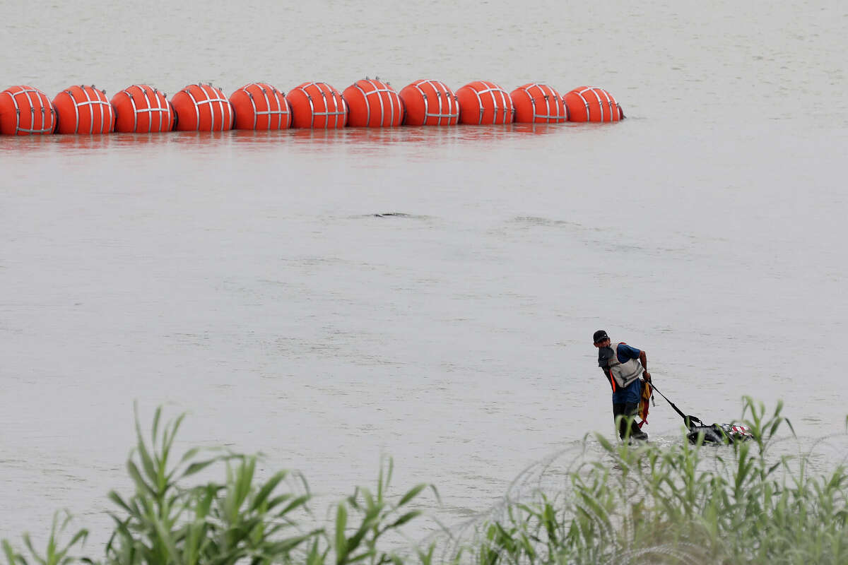 DOJ says it will sue Greg Abbott over buoy barrier in Rio Grande