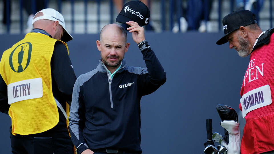 United States' Brian Harman acknowledges the crowd on the 18th green after an eagle putt during the second day of the British Open Golf Championships at the Royal Liverpool Golf Club in Hoylake, England, Friday, July 21, 2023. (AP Photo/Jon Super)