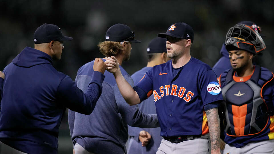 Houston Astros relief pitcher Ryan Pressly, second from right, celebrates with teammates after a 6-4 win over the Oakland Athletics in a baseball game Friday, July 21, 2023, in Oakland, Calif. (AP Photo/Godofredo A. Vásquez)