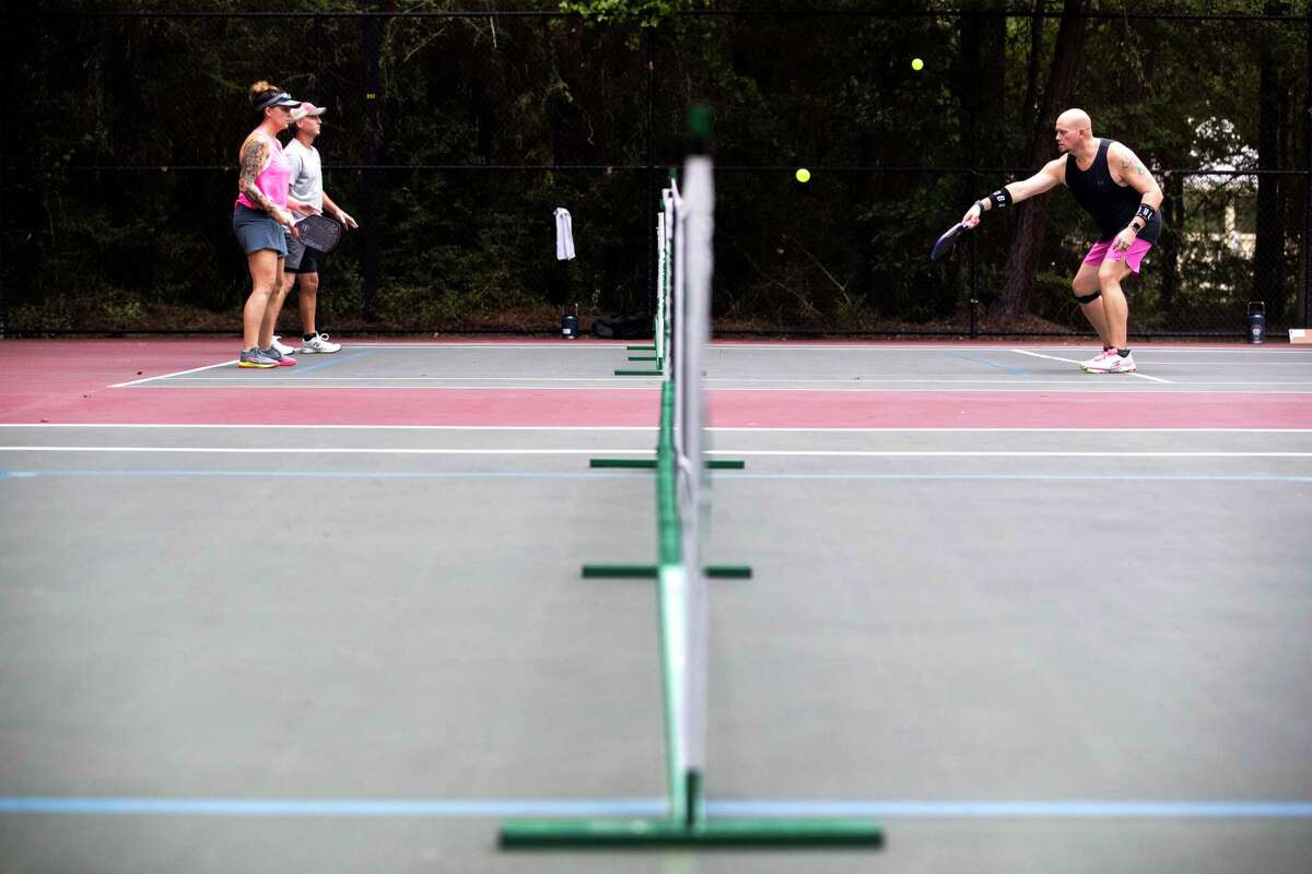 Pickleball players warm up during the DUPR Platinum Ticket Local Waterfall Tournament at Shadowbend Park, Saturday, July 22, 2023, in The Woodlands. Winners of the tournament advanced to play in the national tournament in Rockwall, Texas, in October.