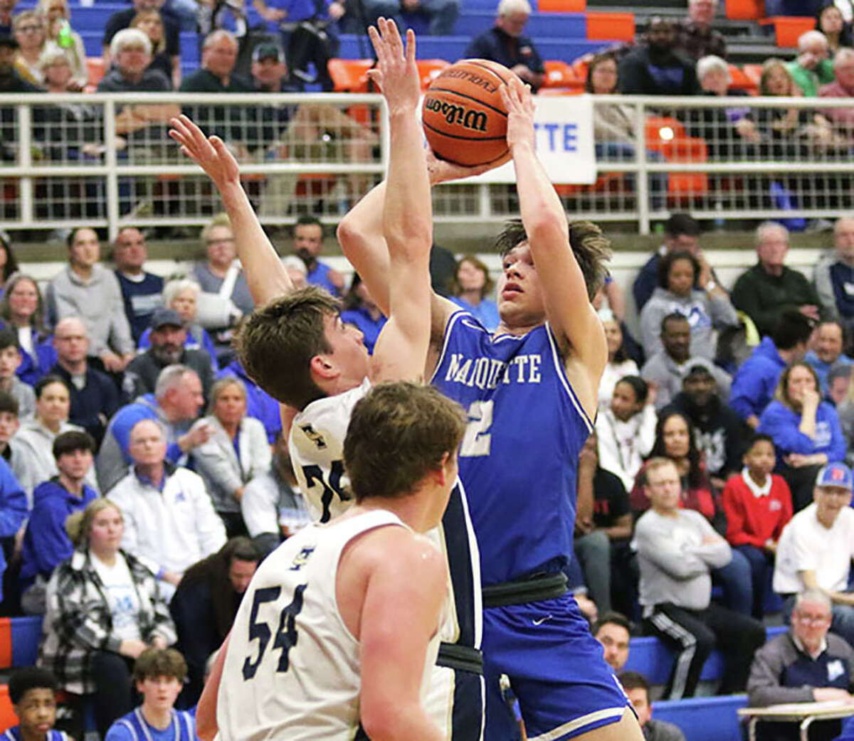 Marquette Catholic junior Braden Kline shoots over Teutopolis' James Niebrugge with the Wooden Shoe's Caleb Siemer (54) also defending the lane in a March 1 semifinal of the Newton Class 2A Sectional. Kline is the 2022-23 Telegraph Small-Schools Boys Basketball Player of the Year.