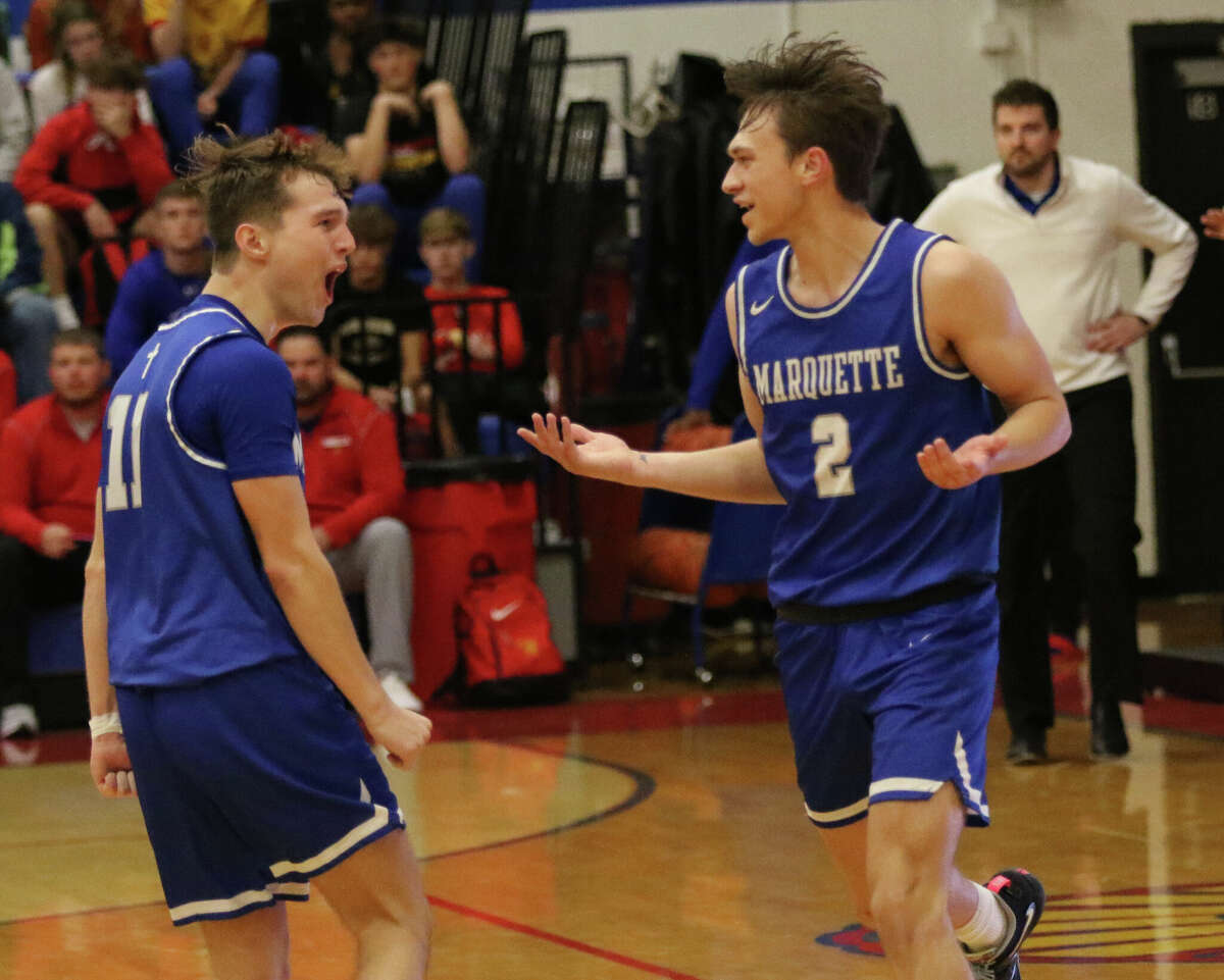 Marquette Catholic's Braden Kline (2) has no explanation for teammate Dre Davis after Kline hit another in a streak of 3s in a game at last season's Roxana Tournament. 