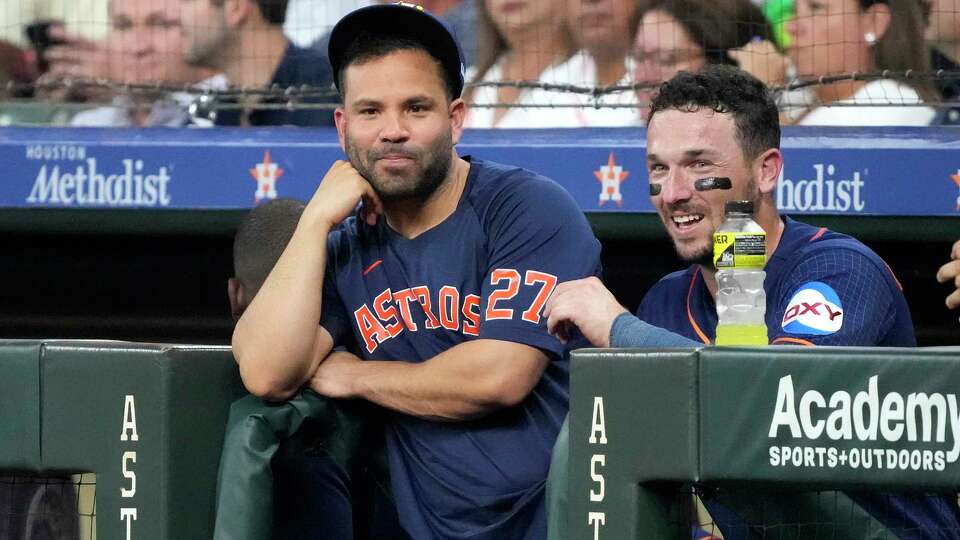 Jose Altuve chats with with Houston Astros third baseman Alex Bregman in the dugout during the first inning of an MLB baseball game at Minute Maid Park on Monday, July 24, 2023 in Houston.