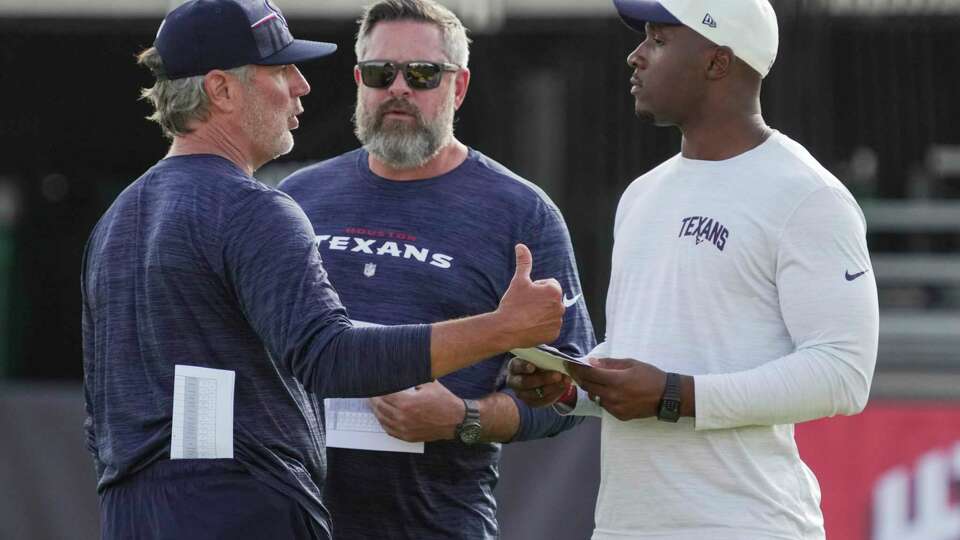 Houston Texans defensive passing game coordinator Cory Undlin, left, talks to defensive coordinator Matt Burke and head coach DeMeco Ryans during an NFL training camp Thursday, July 27, 2023, in Houston.