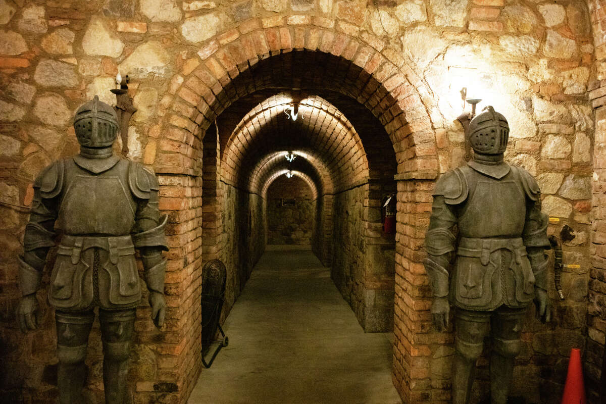 Two suits of armor guard an underground passageway inside the castle.