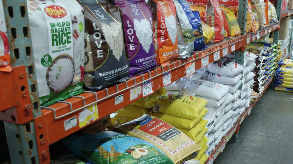 Bags of varying brands and varieties of rice sit on the shelves at Asian Market in Sugar Land Friday, July, 28, 2023.