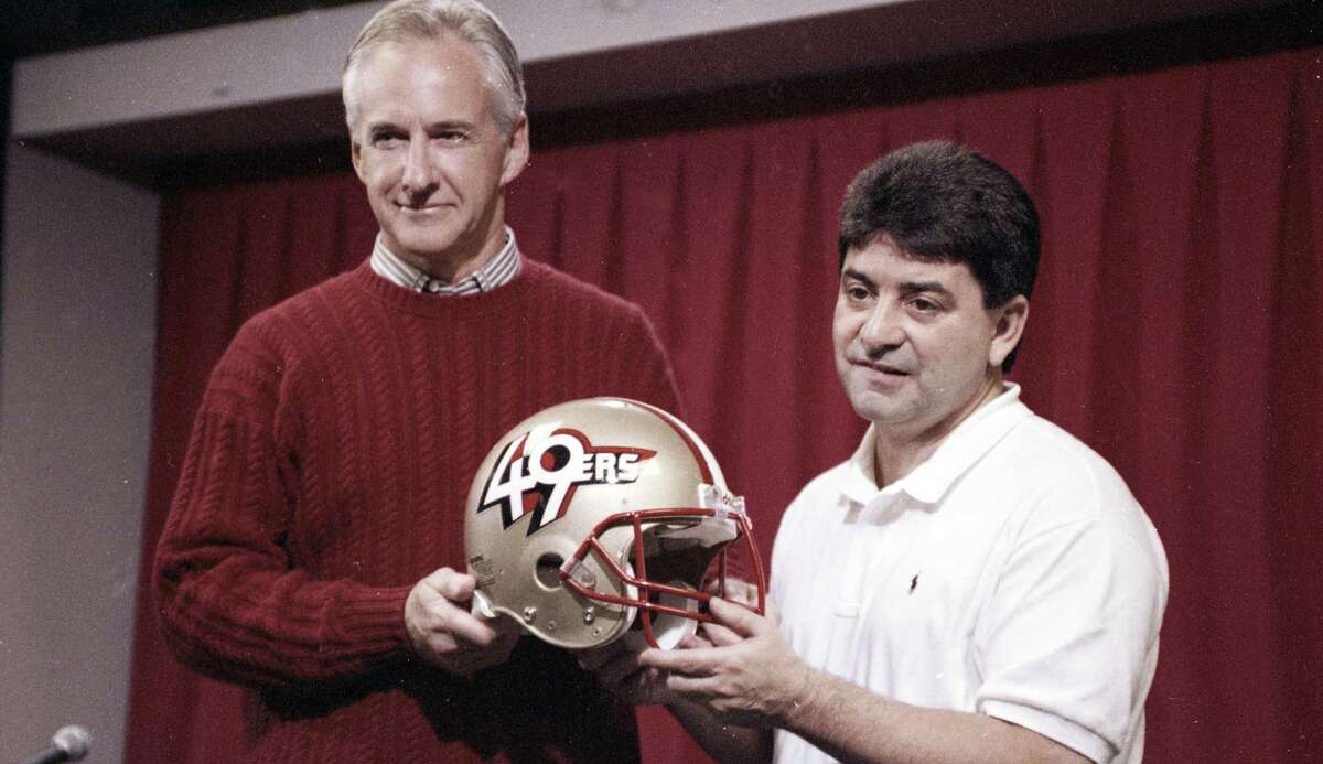 Feb. 13, 1991: The 49ers debut a new helmet, which only lasted one day because of fan protests. Former head coach George Seifert, left, and former team owner Eddie DeBartolo Jr. hold the helmet.