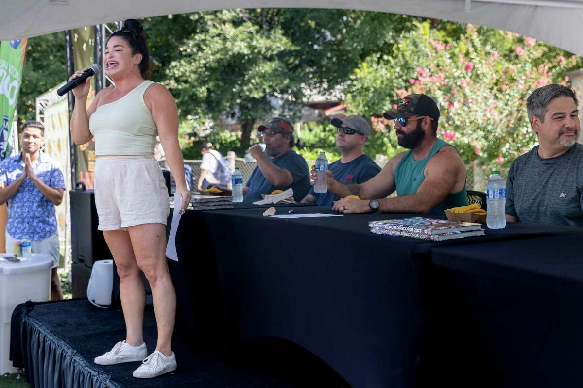 Guinness world record holder Samantha Ramsdell talks to the crown before the start of a taco eating contest Saturday at the San Antonio Zoo.