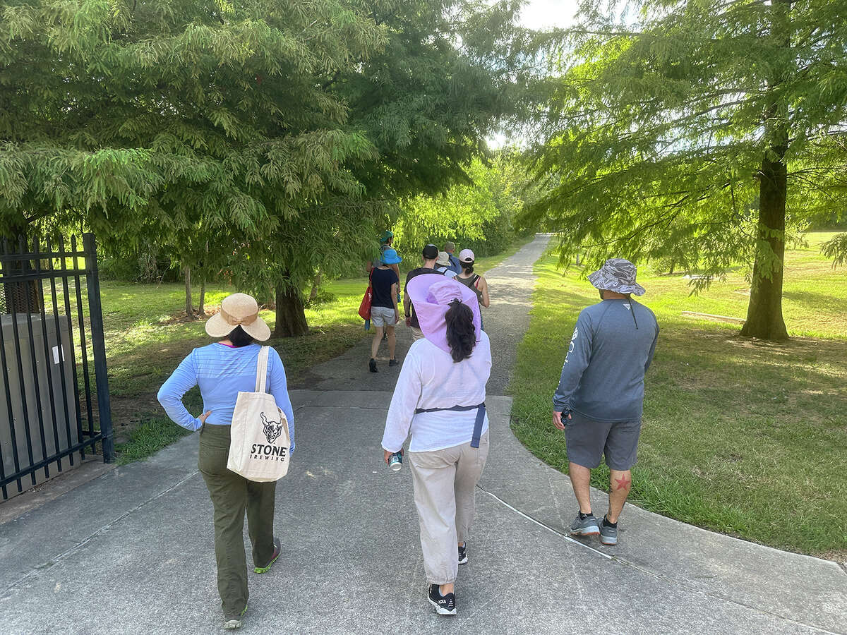 A group heads out for a summer bird walk behind Gary Clark and Schyler Brown at Tony Marron Park along Buffalo Bayou in east Houston. 
