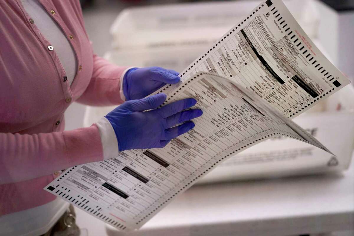 Experts disagree on whether the 14th Amendment ban on office-holders who have aided “insurrection” could prohibit former President Donald Trump from appearing on ballots in 2024.