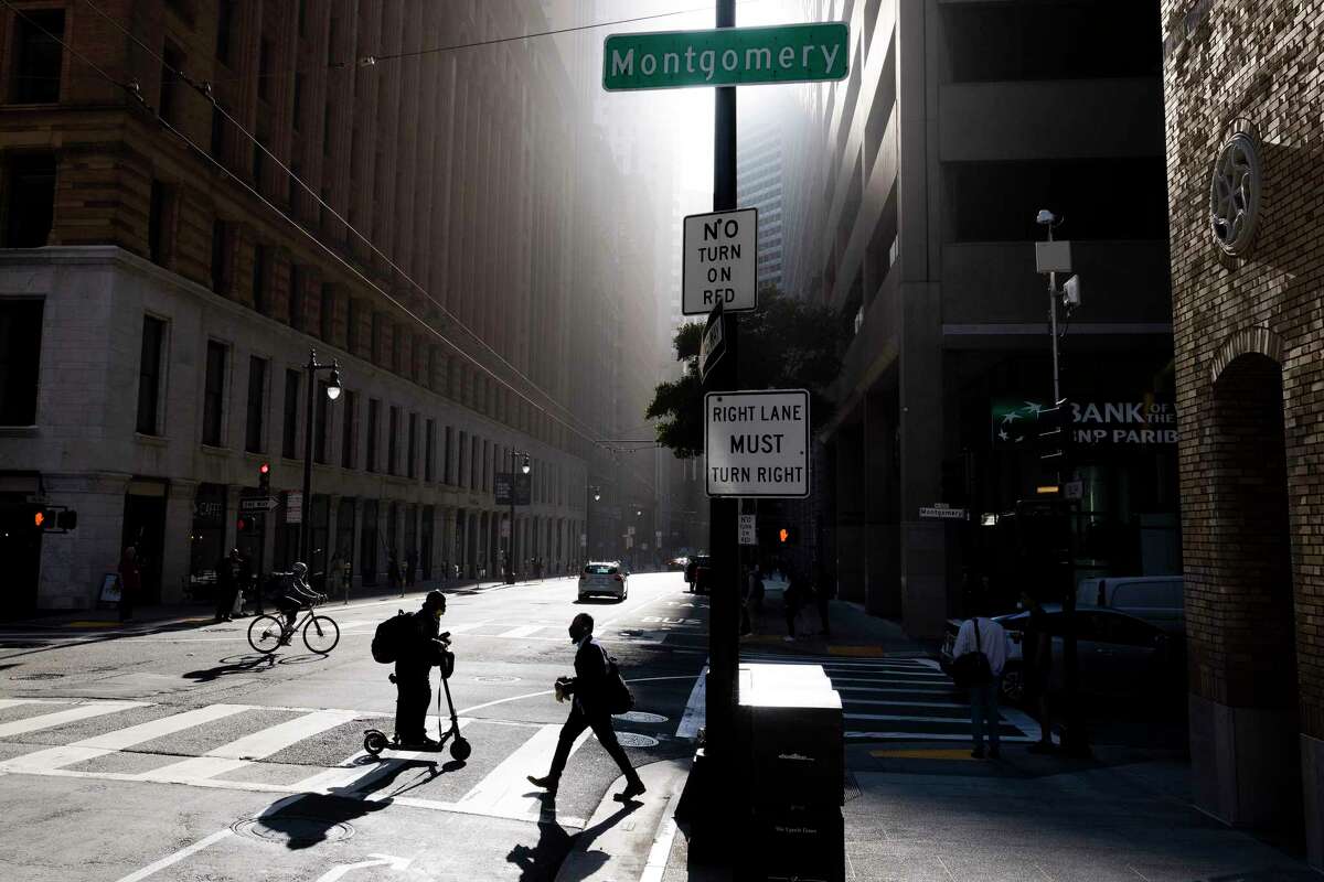 People travel along Sutter Street at Montgomery Street in San Francisco in 2022. To help revitalize the city’s downtown area that has been struggling with inactivity and vacancies, city leaders are thinking about bringing in a college campus. 