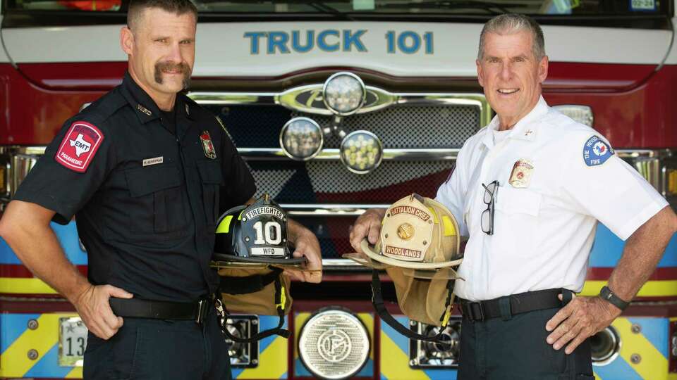 Mike Berryman, right, poses for a portrait alongside his son, Scott, at The Woodlands Central Fire Station, Friday, Aug. 4, 2023, in The Woodlands. Mike Berryman recently retired after 42 years with the department where both his son and his son-in-law serve.