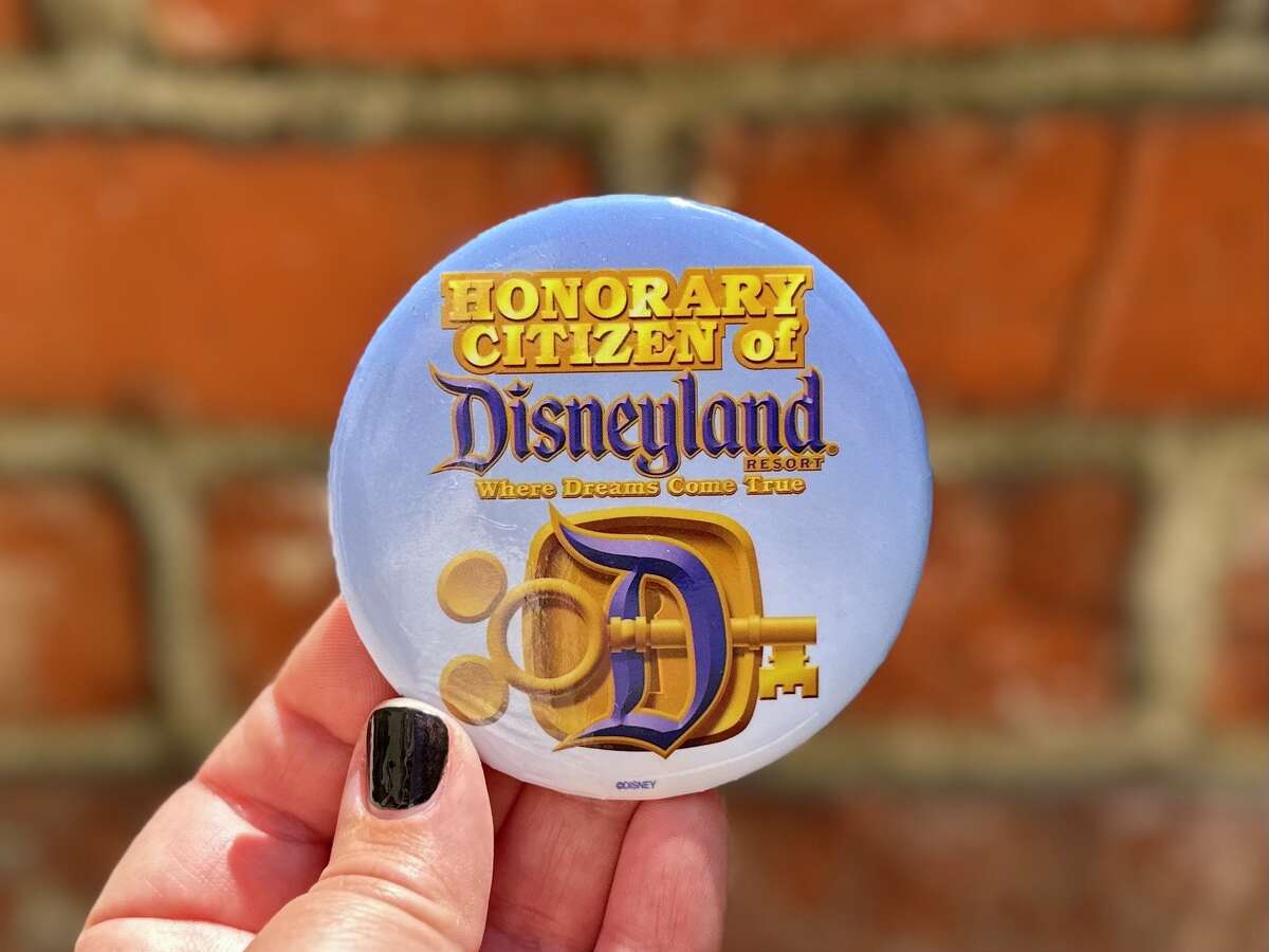 Unlike the other buttons at Disneyland, you have to earn the right to become an honorary citizen.