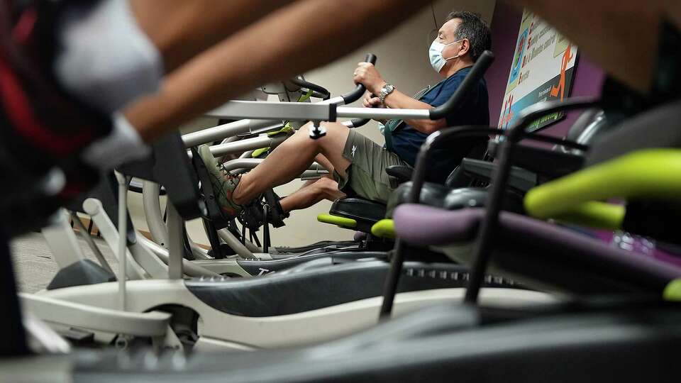 John Longoria, 63, works out on a stationary recumbent bike as part of his rehabilitation from having a heart attack at Memorial Hermann on Friday, Aug. 4, 2023 in Houston. Longoria had a heart attack after mowing his lawn earlier this summer, partly from heat stress.