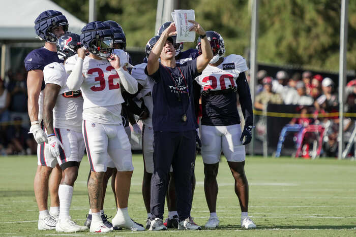 Houston Texans punter Cameron Johnston (11) tosses a bottle during warm-ups  before an NFL football game against the Jacksonville Jaguars on Sunday, Oct.  9, 2022, in Jacksonville, Fla. (AP Photo/Gary McCullough Stock