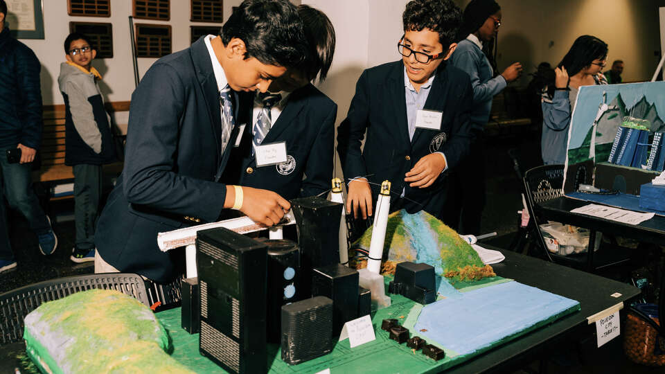 Students of The Village School demonstrate a turning battery coil in their model city, Poseidon City, made for The Houston Future City Competition in Houston, Texas on Saturday, Jan. 21, 2023.