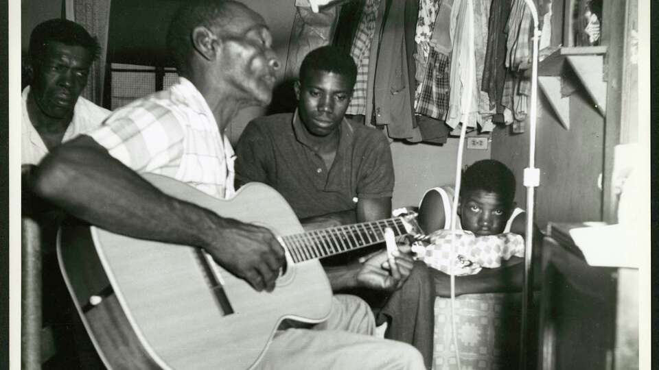 Navasota blues musician Mance Lipscomb and his family, photographed by Mack McCormick. The photo is included in the new box set 