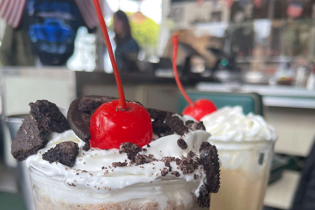 The Lana Del Rey milkshake (a chocolate shake blended with oreo crumbles), foreground, at Mel's Drive-In, alongside a classic coffee milkshake.