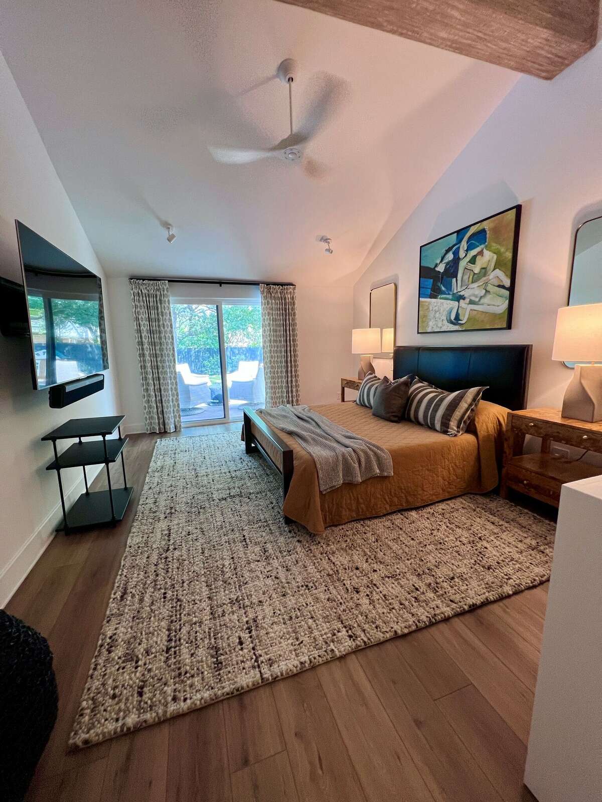 By stealing space from the attic above, they were able to turn the primary bedroom's flat ceiling  into a vaulted ceiling and give the room a more appealing, airy and open feel.