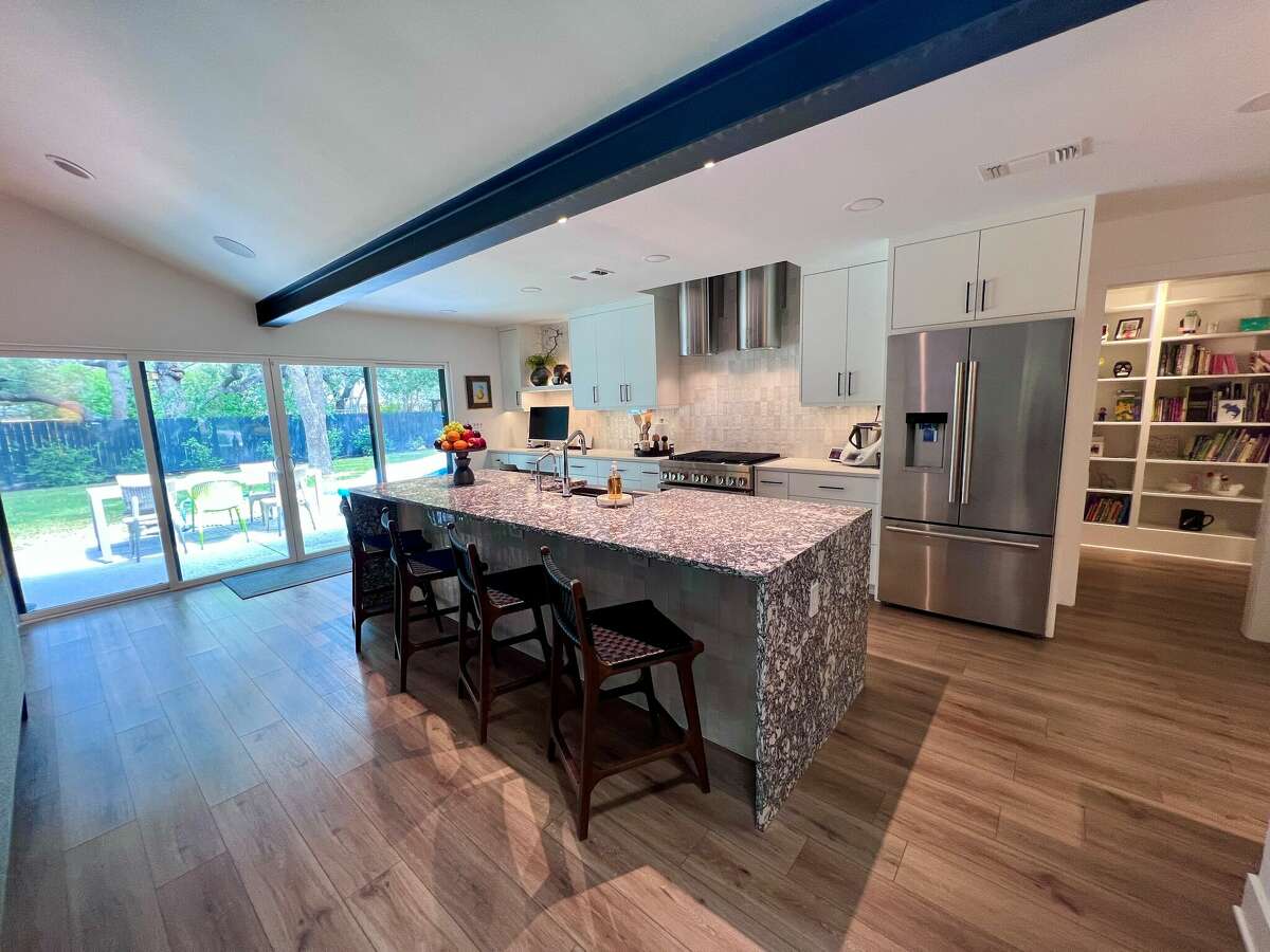 Several of the walls that were removed during the renovation were load-bearing, so they installed an exposed steel I-beam to provide needed support — and it was left exposed rather than being covered up.