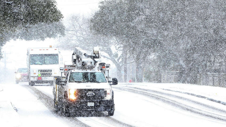 CPS Energy work crews were seen driving along Vance Jackson Road during another day of snow fall in San Antonio on Thursday, Feb 18, 2021.